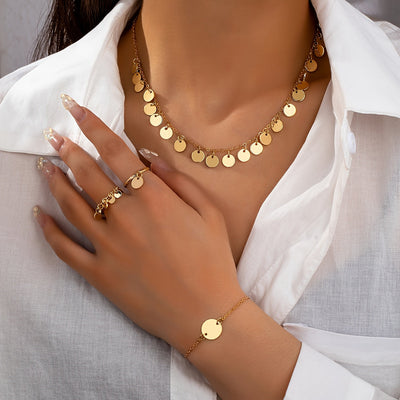 Parure collier, bracelet et 2 bagues en or 18K avec pendentifs dorés